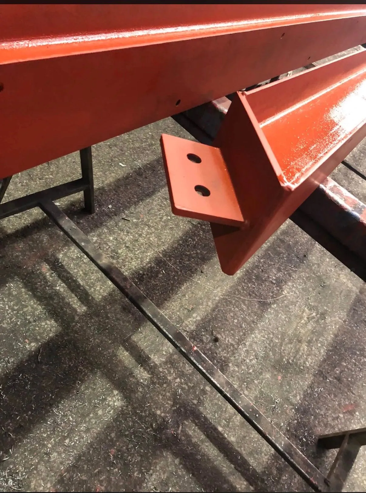 Fabricated steel beam connection bracket with welded plate and prepared bolt holes