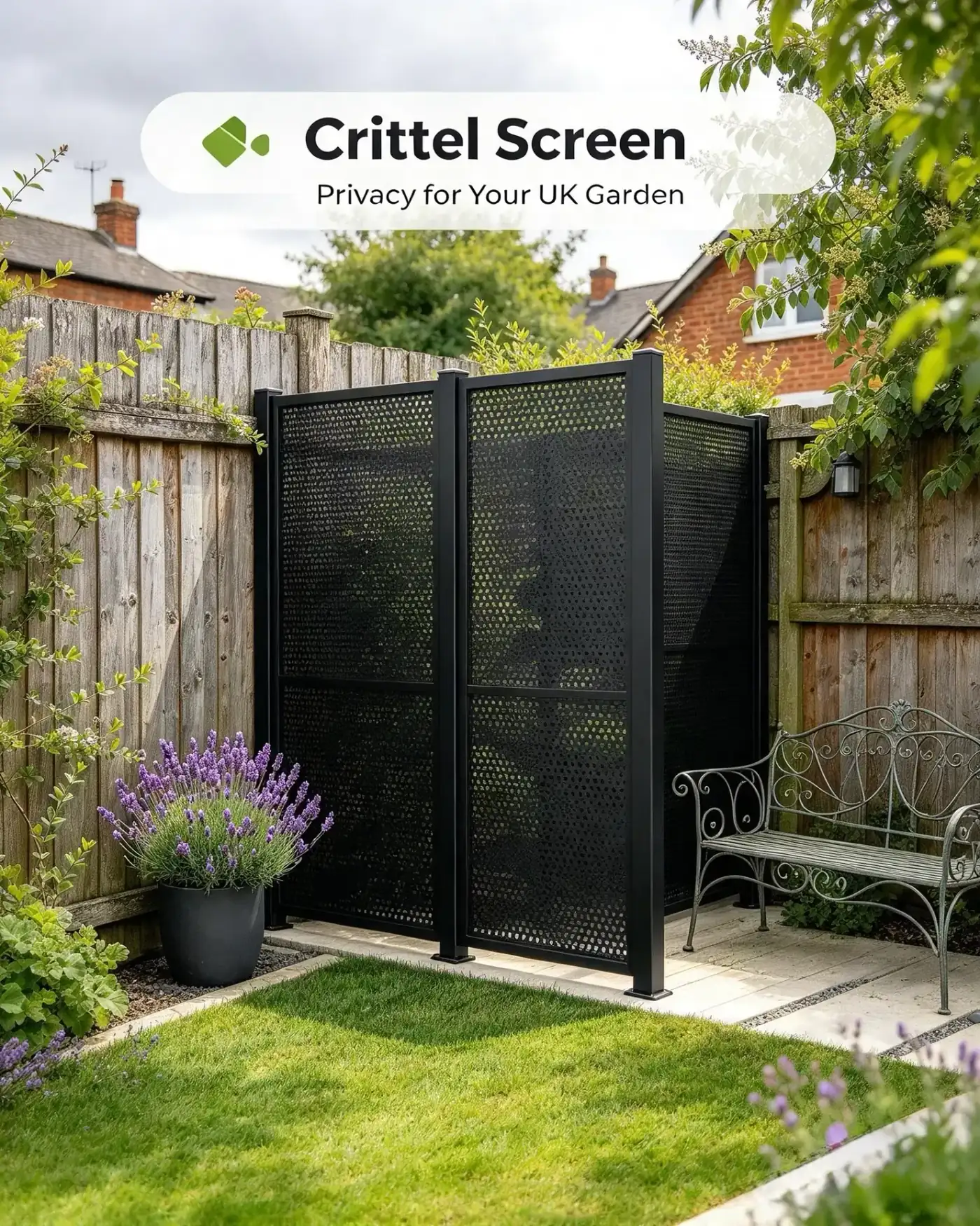 Black perforated steel privacy screens in a landscaped garden with lawn and planting